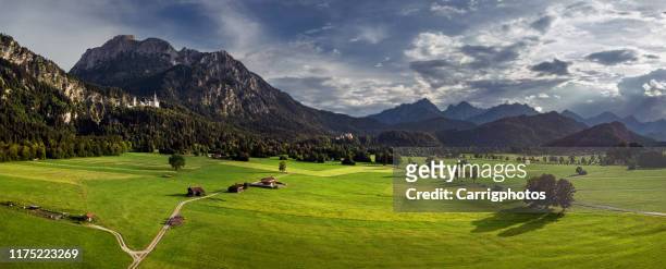 rural landscape with neuschwanstein and hohenschwangau castles in distance, schwangau, bavaria, germany - hohenschwangau castle stock pictures, royalty-free photos & images
