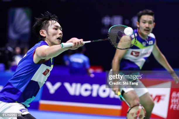 Takeshi Kamura and Keigo Sonoda of Japan compete in the Men's Doubles first round match against Goh Sze Fei and Nur Izzuddin of Malaysia on day one...