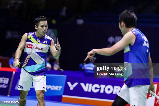 Takeshi Kamura and Keigo Sonoda of Japan react in the Men's Doubles first round match against Goh Sze Fei and Nur Izzuddin of Malaysia on day one of...