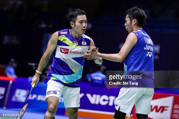Takeshi Kamura and Keigo Sonoda of Japan react in the Men's Doubles first round match against Goh Sze Fei and Nur Izzuddin of Malaysia on day one of...