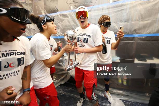 Aerial Powers of the Washington Mystics and Elena Delle Donne of the Washington Mystics celebrate with the WNBA Championship Trophy after a win...