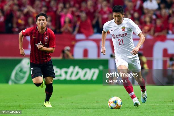 Yu Hai of Shanghai SIPG drives the ball during the AFC Champions League quarter-final 2nd leg match between Urawa Red Diamonds and Shanghai SIPG at...