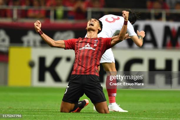Tomoaki Makino of Urawa Red Diamonds celebrates the victory at the end of the AFC Champions League quarter final second leg match between Urawa Red...