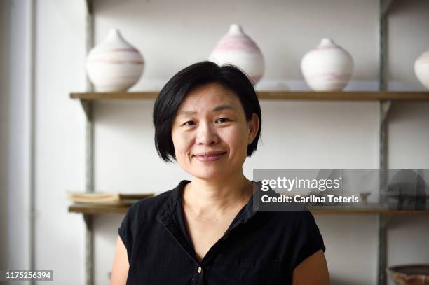 portrait of a singaporean woman in her store - asian woman stock pictures, royalty-free photos & images