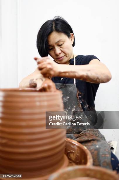 Mature woman working on a potter's wheel
