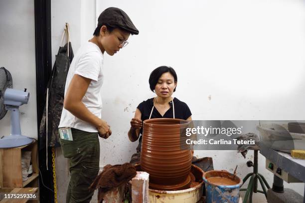 Women discussing a pottery project