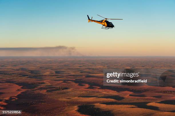 helicopter over uluru-kata tjuta national park - uluru-kata tjuta national park stock pictures, royalty-free photos & images