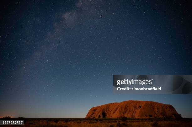 the night sky over uluru - uluru rock stock pictures, royalty-free photos & images