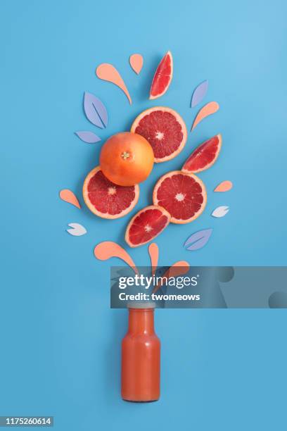 grapefruit fruits and juice in bottle. - liquid explosion stock pictures, royalty-free photos & images