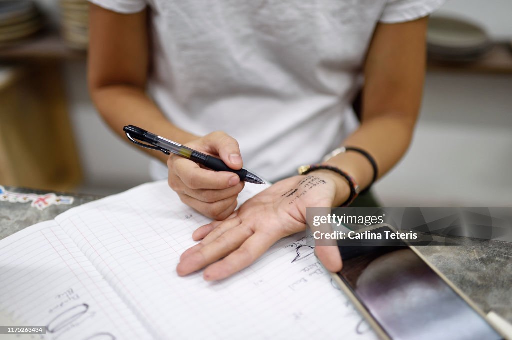 Business woman taking notes on her hand