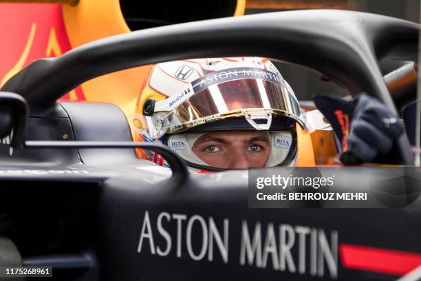 Red Bull Racing's Dutch driver Max Verstappen waits to leave the pit during the first practice session for the Formula One Japanese Grand Prix at...