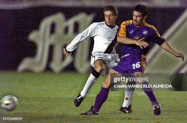 Cansino of the team Deportivo Concepcion de Chile and Juninho of Vasco da Gama chase a loose ball during a qualifying match for the Copa Libertadores...