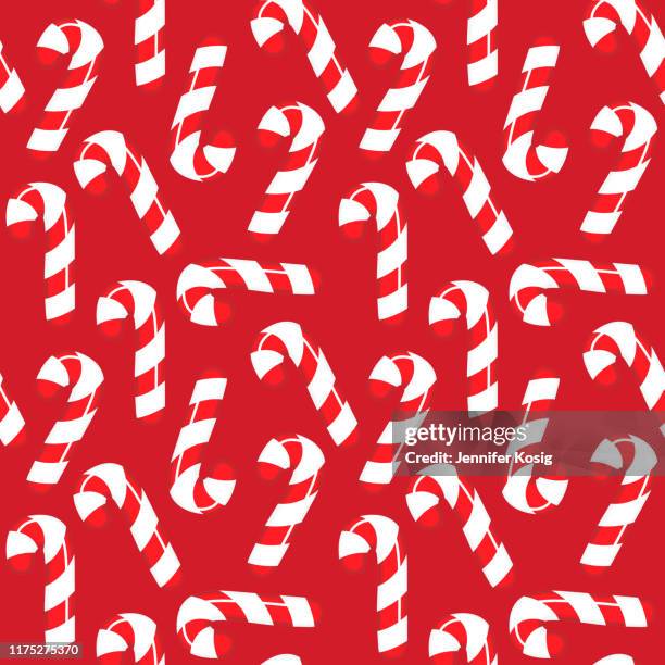 seamless candy cane christmas illustration pattern, red background - peppermint candy vector stock illustrations