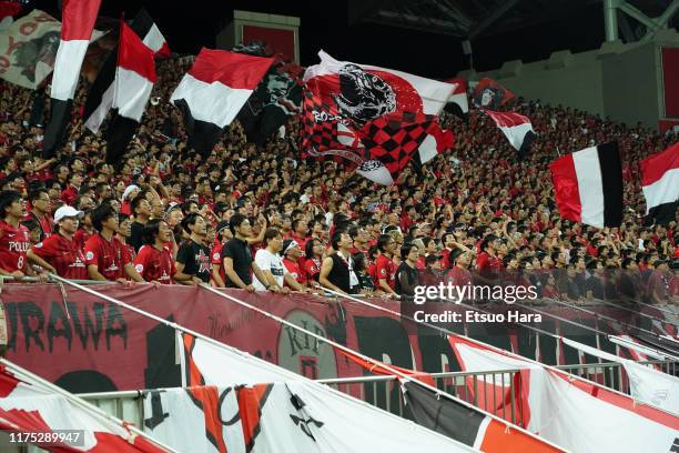 Fans of Urawa Red Diamonds cheer during the AFC Champions League quarter final second leg match between Urawa Red Diamonds and Shanghai SIPG at...
