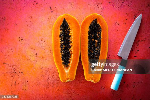 papaya open in two split knife cut tropical fruit - papaya stock pictures, royalty-free photos & images