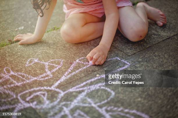 girl drawing  with sidewalk chalk - chalk art equipment stock pictures, royalty-free photos & images
