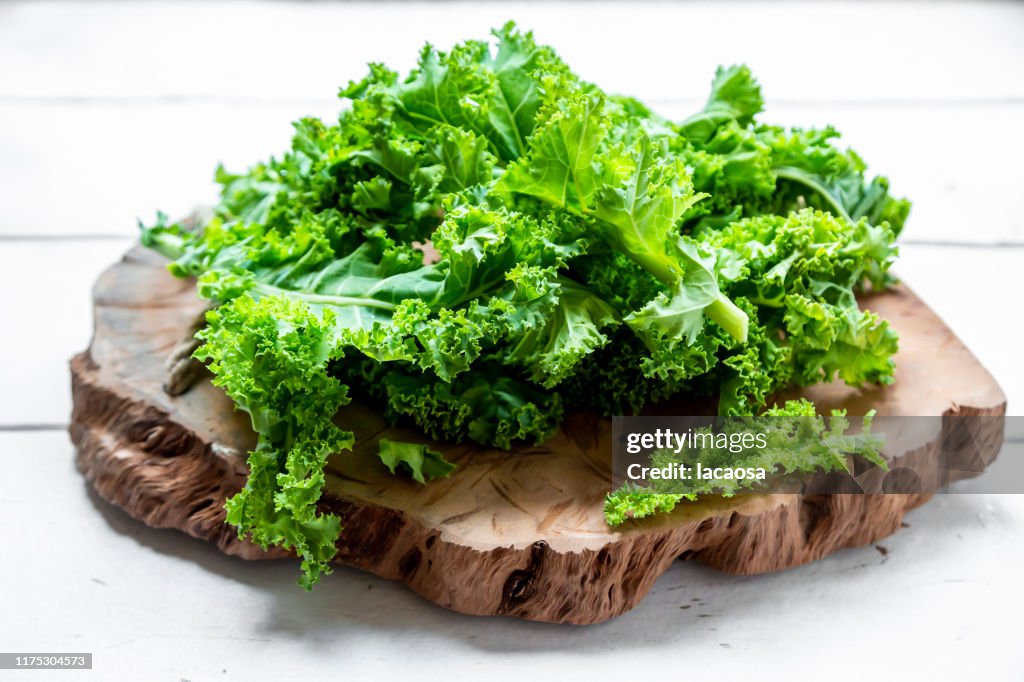 Fresh organic kale on wood