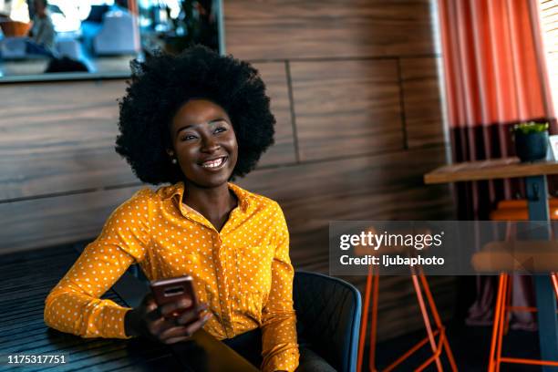 girl using her smartphone to send audio message - dark skin tone stock pictures, royalty-free photos & images