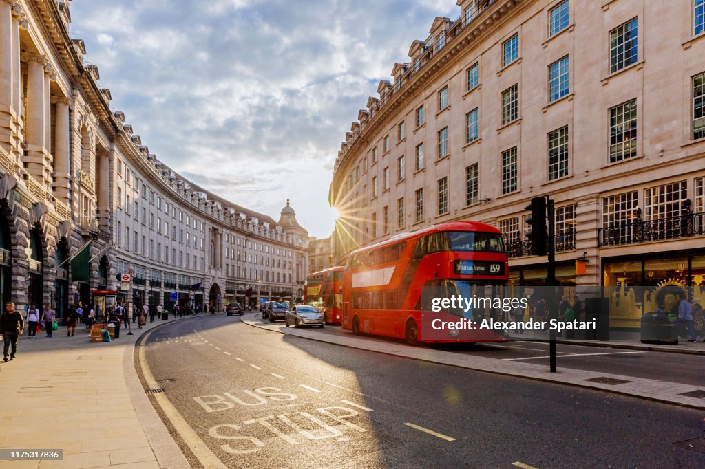 Regent Street  with sun shining through buildings during sunset, London, England, UK