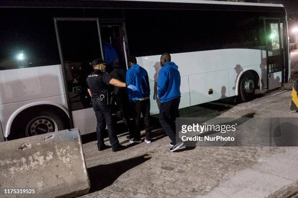 Group of rescued migrants leaves the Care unit to take a bus, which will transfer them to a center, in Malaga, southern of Spain, on October 9, 2019.