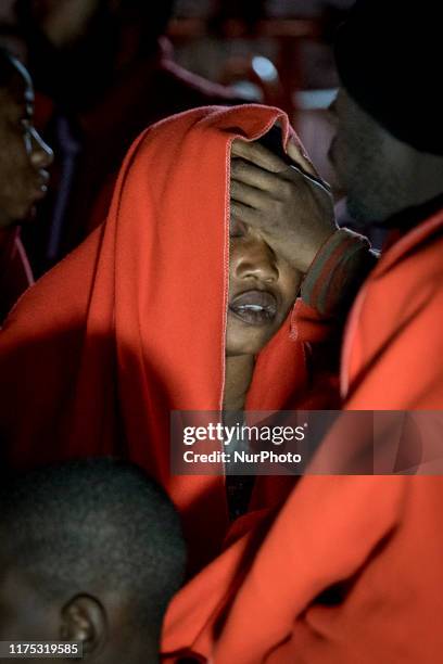 Rescued woman is about to faint as she is disembarking at the Malaga's harbour, in Malaga, southern of Spain, on October 9, 2019.