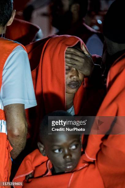 Rescued woman is about to faint as she is disembarking at the Malaga's harbour, in Malaga, southern of Spain, on October 9, 2019.