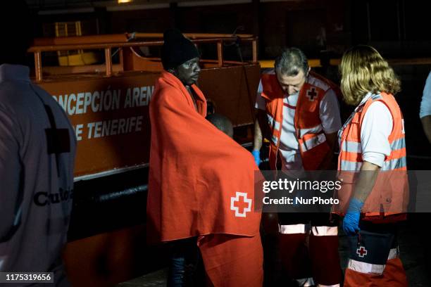 Father with a young boy are being attended by the Red Cross staffs at the Malaga's harbour, in Malaga, southern of Spain, on October 9, 2019.