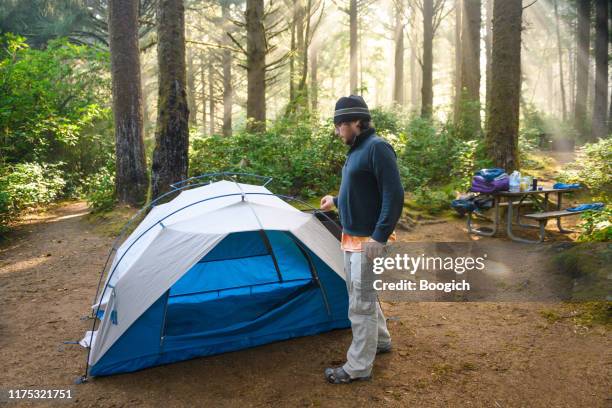 man tent camping in the pacific northwest forest oregon usa - oregon coast stock pictures, royalty-free photos & images