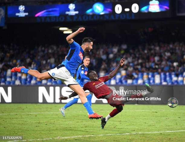 Sadio Mane of Liverpool stretches for the ball with Konstantinos Manolas of Napoli during the UEFA Champions League group E match between SSC Napoli...