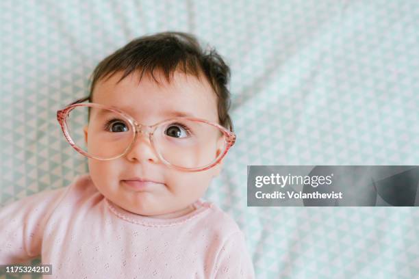 cute baby girl with woman glasses making funny faces - funny face baby stock pictures, royalty-free photos & images