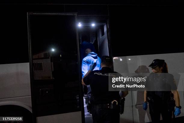 Group of rescued migrants leaves the Care unit to take a bus, which will transfer them to a center, in Malaga, southern of Spain, on October 9, 2019.