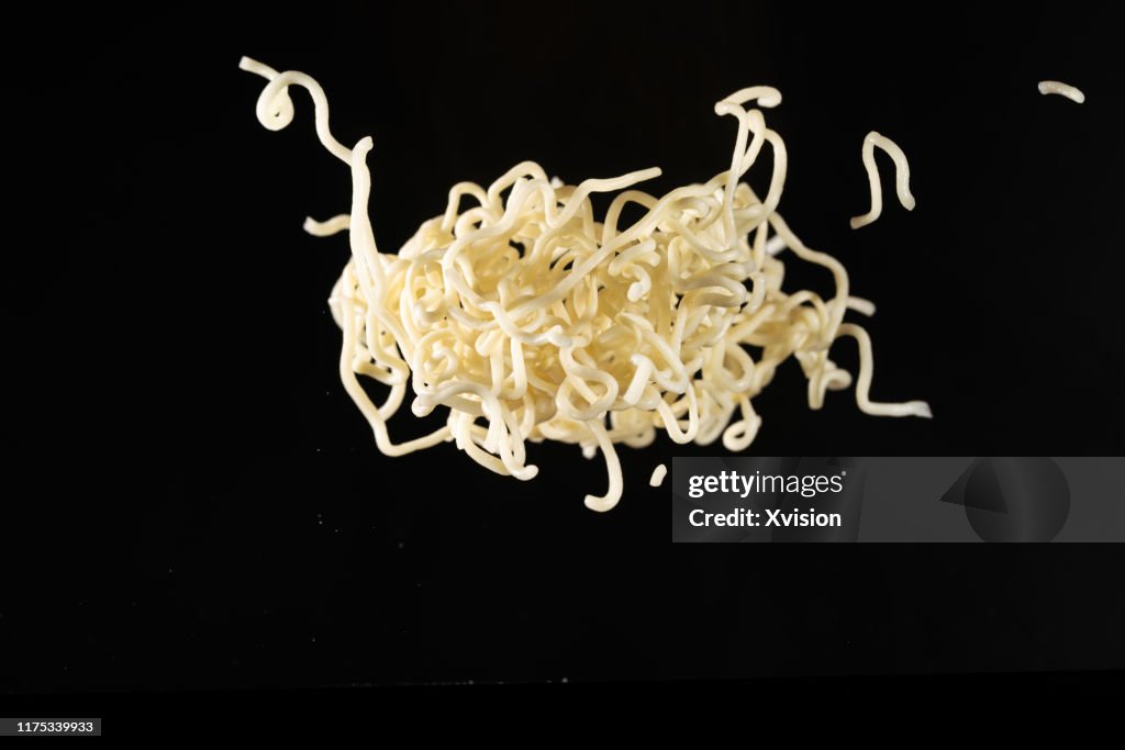 Instant noodle flying in mid air captured with high speed sync.