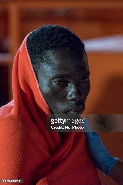 Rescued migrant can finally rest as he just disembark from the Spanish Maritime vessel. A rescued woman is about to faint as she is disembarking at...
