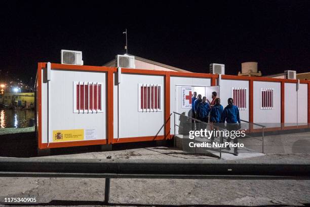 Group of rescued migrants leaves the Care unit to take a bus, which will transfer them to a center, in Malaga, southern of Spain, on October 9, 2019.