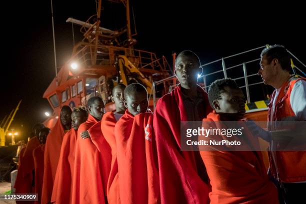 Group of men queues, after disembarking, to go to the Red Cross Care Unit, in Malaga, southern of Spain, on October 9, 2019.