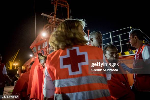 Group of men queues, after disembarking, to go to the Red Cross Care Unit, in Malaga, southern of Spain, on October 9, 2019.