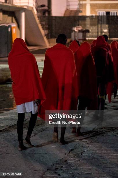 Group of men queues, after disembarking, to go to the Red Cross Care Unit, in Malaga, southern of Spain, on October 9, 2019.