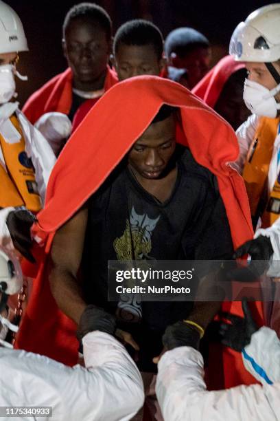 Migrant disembarks, helped by the rescue workers, in Malaga, southern of Spain, on October 9, 2019.