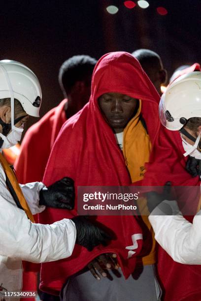 Migrant disembarks, helped by the rescue workers, in Malaga, southern of Spain, on October 9, 2019.