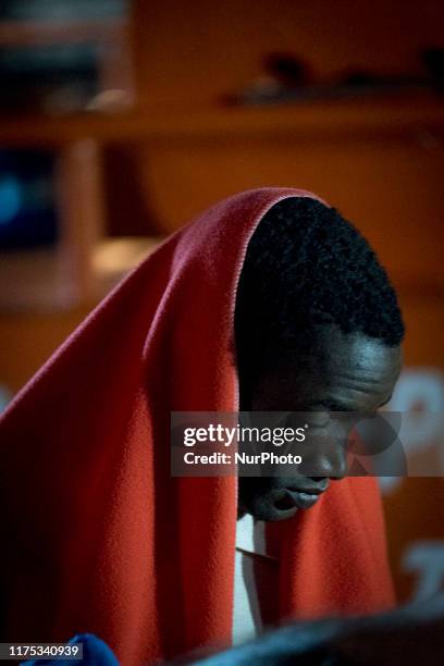 Rescued migrant can finally rest as he just disembark from the Spanish Maritime vessel. A rescued woman is about to faint as she is disembarking at...