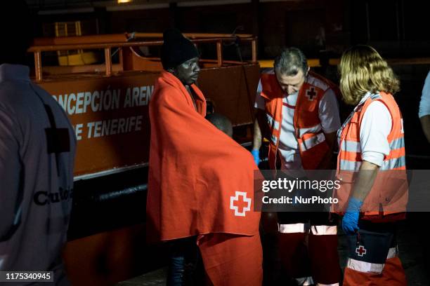 Father with a young boy are being attended by the Red Cross staffs at the Malaga's harbour, in Malaga, southern of Spain, on October 9, 2019.