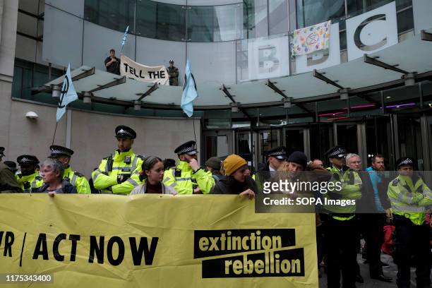 Environmental activists holding a Large banner in front of the BBC building main entrance during the demonstration. Extinction Rebellion...