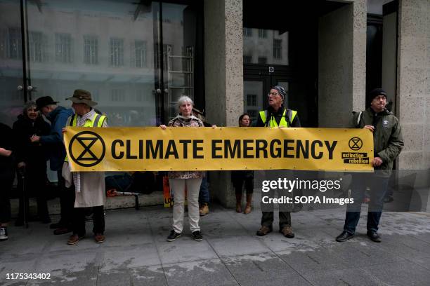 Environmental protesters holding a banner that reads, Climate emergency, during the demonstration. Extinction Rebellion environmental activists...