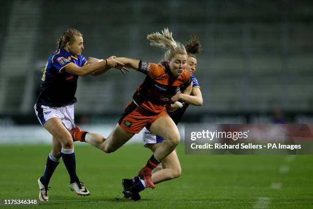 Castleford Tigers Women Tara Stanley is tackled by Leeds Rhino's Women Dannielle Anderson and Leeds Rhino's Women Sophie Nutall during the Betfred...