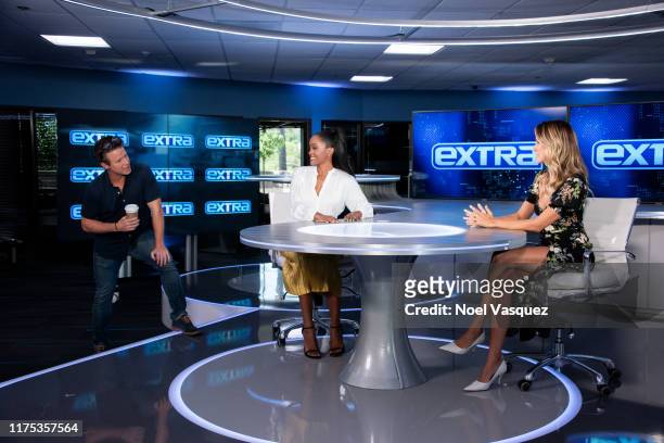 Billy Bush, Rachel Lindsay and Renee Bargh visit "Extra" at Burbank Studios on September 17, 2019 in Burbank, California.