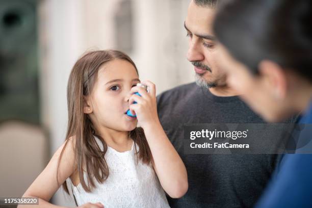 preschool age girl with asthma learns to use an inhaler - asthma inhaler child stock pictures, royalty-free photos & images