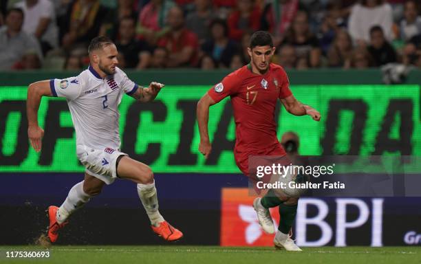 Goncalo Guedes of Portugal and Valencia with Maxime Chanot of Luxembourg in action during the UEFA Euro 2020 Qualifier match between Portugal and...