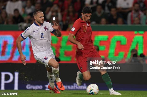 Goncalo Guedes of Portugal and Valencia with Maxime Chanot of Luxembourg in action during the UEFA Euro 2020 Qualifier match between Portugal and...