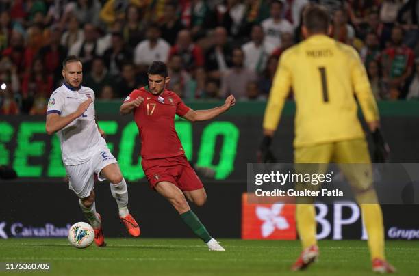 Goncalo Guedes of Portugal and Valencia with Maxime Chanot of Luxembourg in action during the UEFA Euro 2020 Qualifier match between Portugal and...