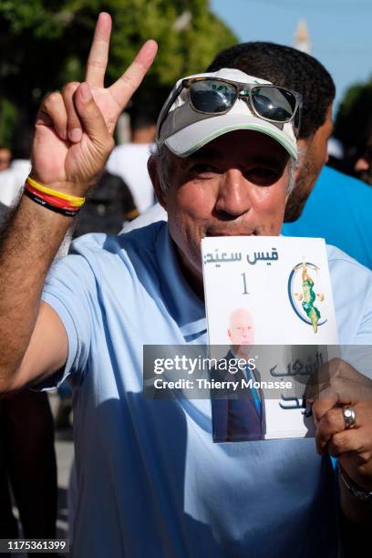 Supporters of the Tunisian presidential candidate, Kais Saied are waiting for there leaders during a presidential campaign rally on October 11 in...